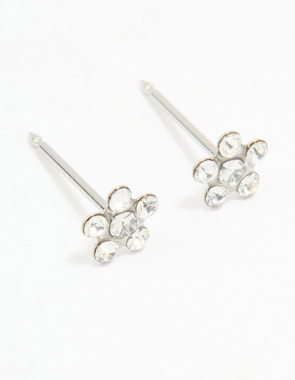 Discover dainty surgical stainless steel cubic zirconia daisy piercing studs in silver and clear front view