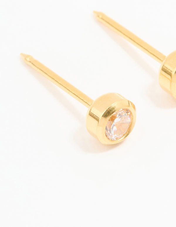 Showcasing 24K gold plated surgical stainless steel 3MM cubic zirconia bezel piercing studs with crystal design and stud closure close up view