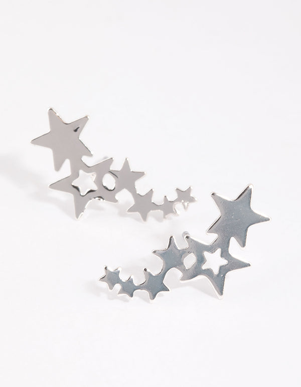 Highlighting silver star crawler earrings with celestial details close up view