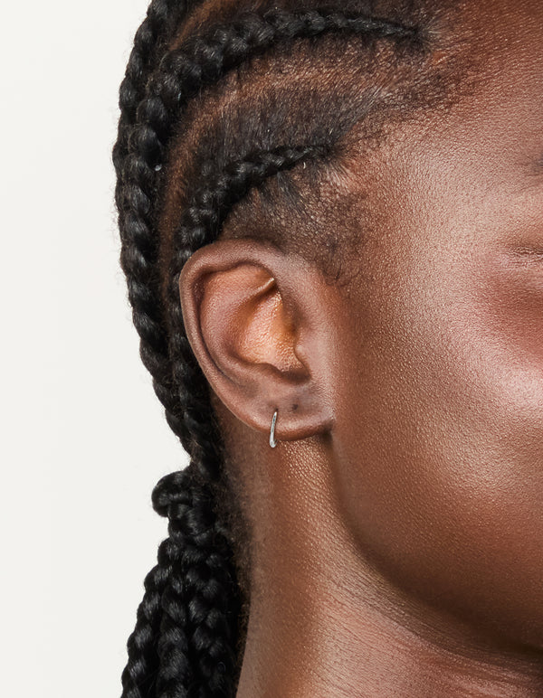 Showcasing titanium fine sleeper earring 8mm in silver on ear view