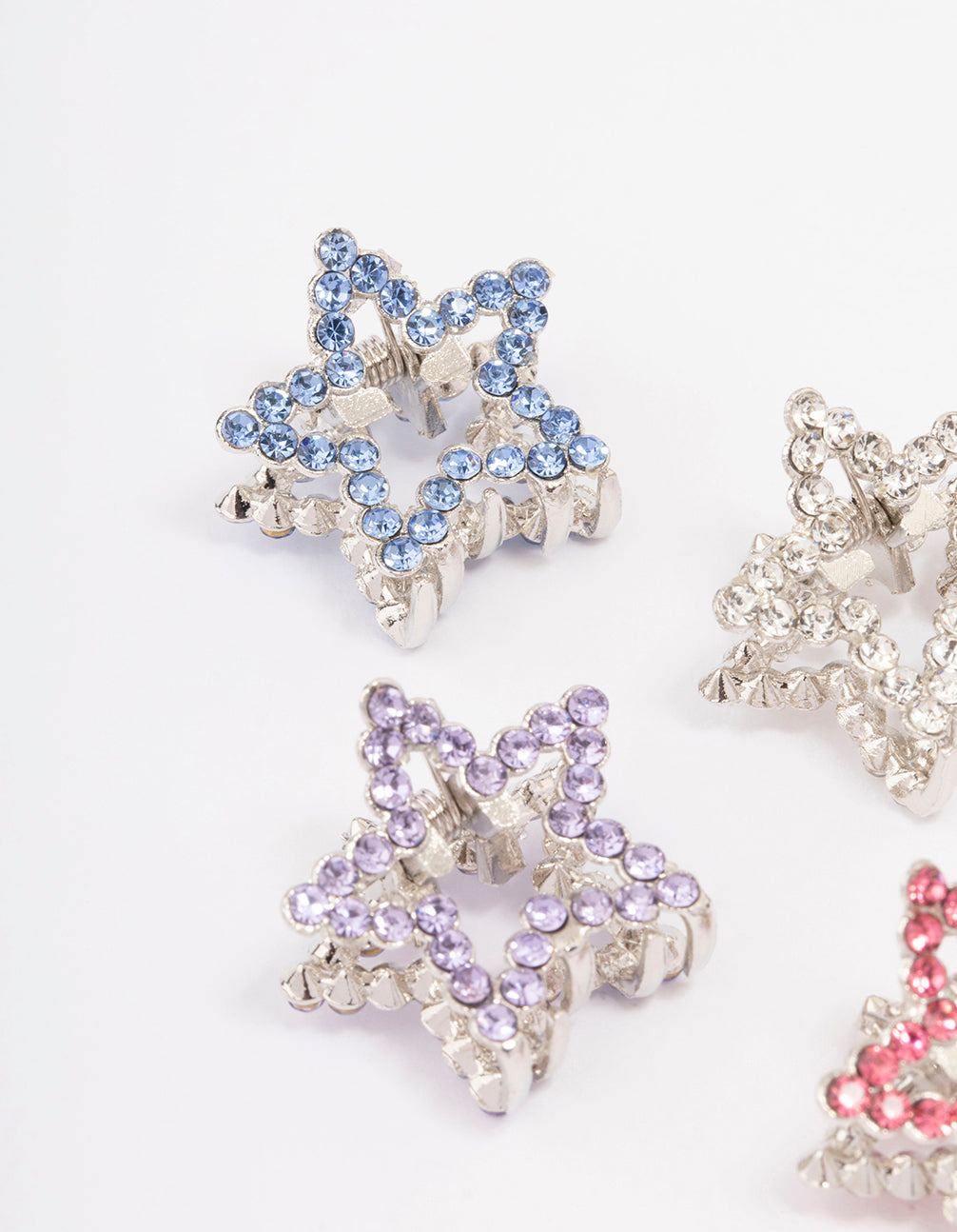 Featuring celestial star embellishments, the silver mini diamante hair claw clip 4-pack side view