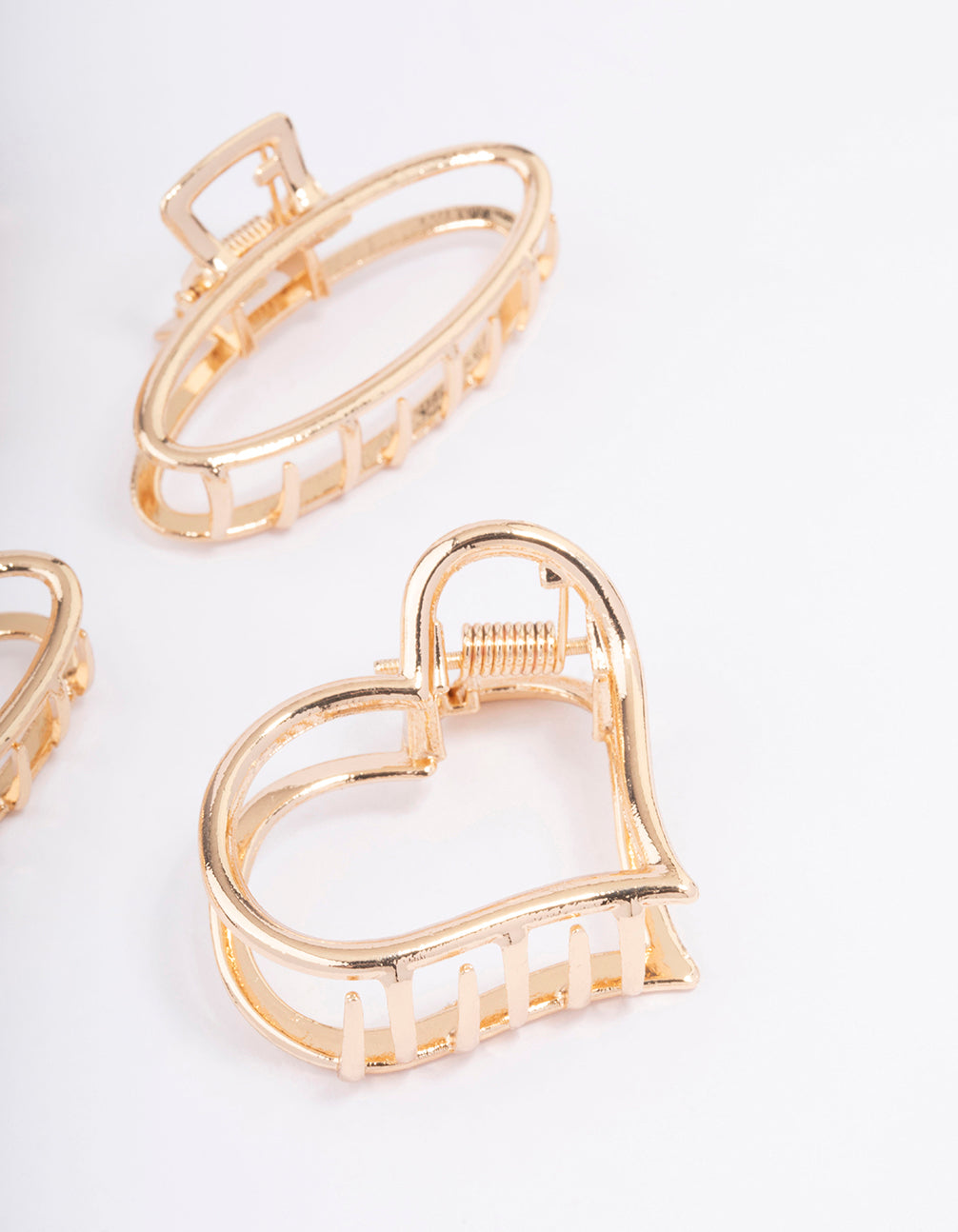 Designed with solid heart and oval gold hair claw clip 4-pack detail view