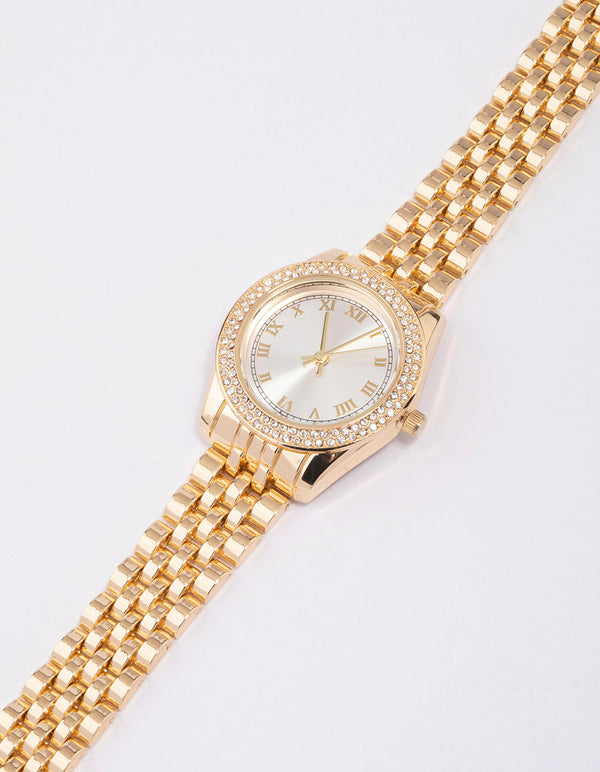Explore this gold diamante encrusted watch featuring a white dial with roman numerals, round dial shape, designed for women, formal occasions, analog type, and link band strap watch face detail view