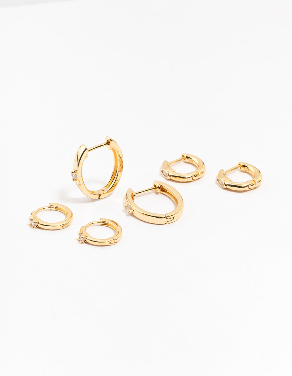 Discover gold plated brass graduating cubic zirconia earrings with hoop closure front view