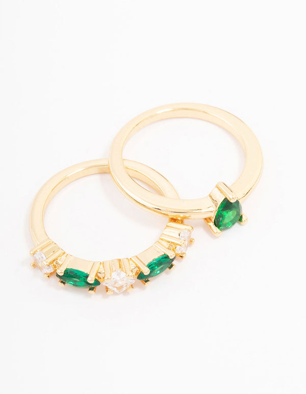 Presenting gold plated alternating cubic zirconia pear stacking ring pack with emerald cut stones side detail view