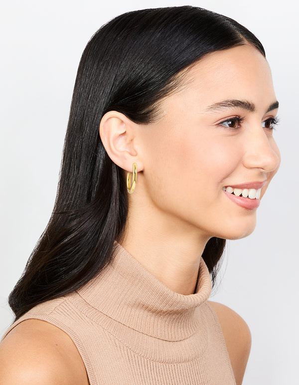 Featuring waterproof gold plated stainless steel clicker hoop earrings in 24 MM on model view