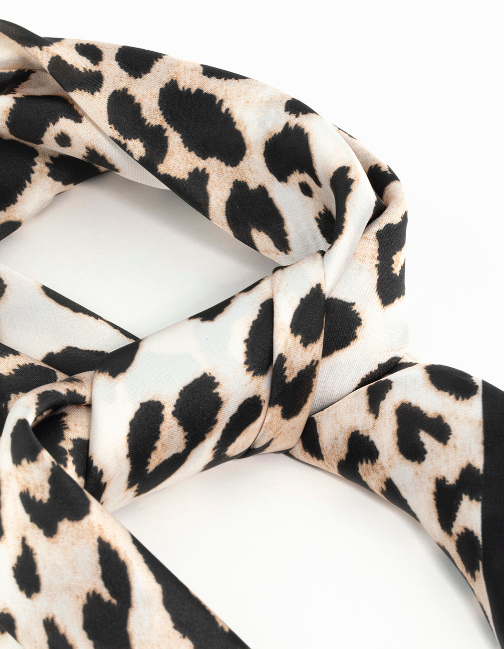 Elegant leopard print satin scarf crafted from fabric in black beige tan and white detail view