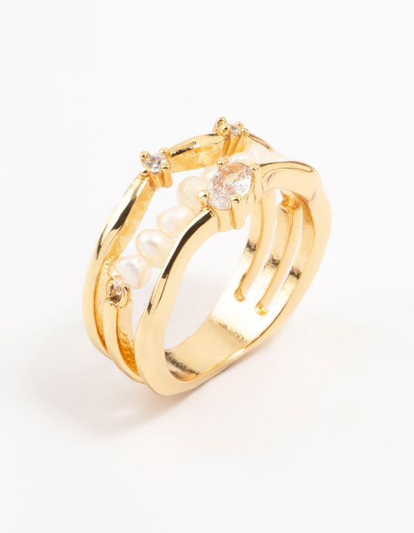 Crafted from gold plated material, a nestled pearl layered ring with statement style front view