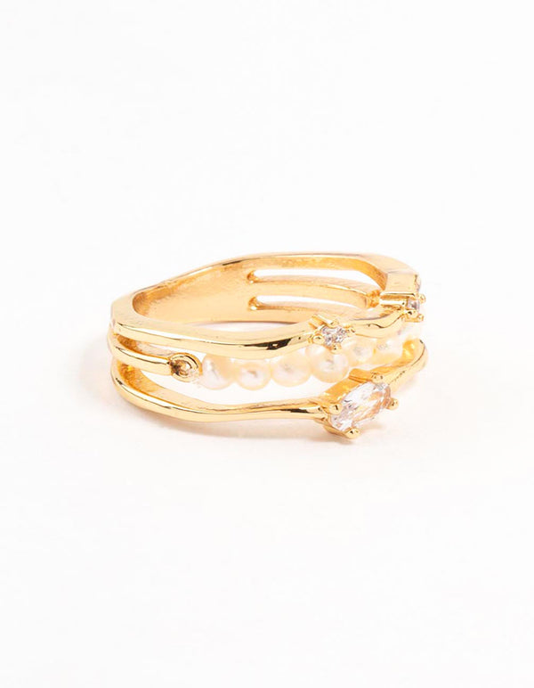 Showcasing a gold plated nestled pearl layered ring with statement design side detail view
