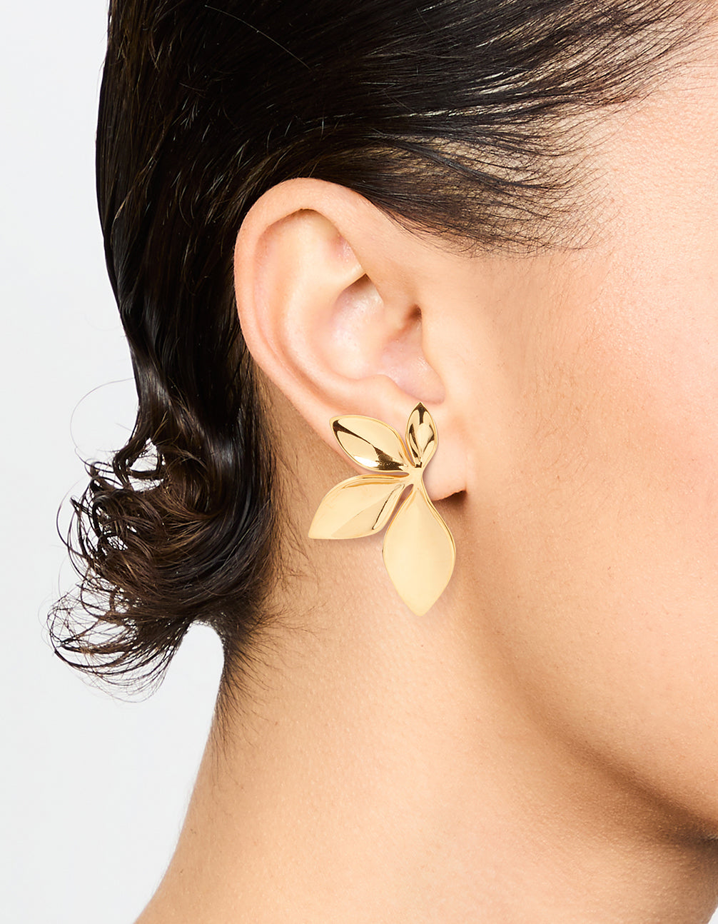 Featuring waterproof gold plated stainless steel leaf cluster stud earrings on ear view