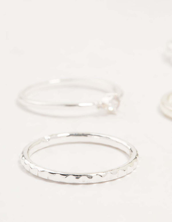 Highlighting silver plated dainty diamante stacking rings 5-pack with textured band close up view
