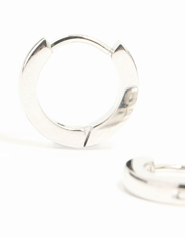Designed with waterproof stainless steel thin clicker earrings featuring huggie closure in silver close up view
