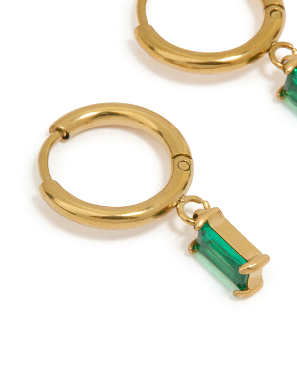 Featuring waterproof gold plated stainless steel huggie earrings with green baguette stone cut close up view