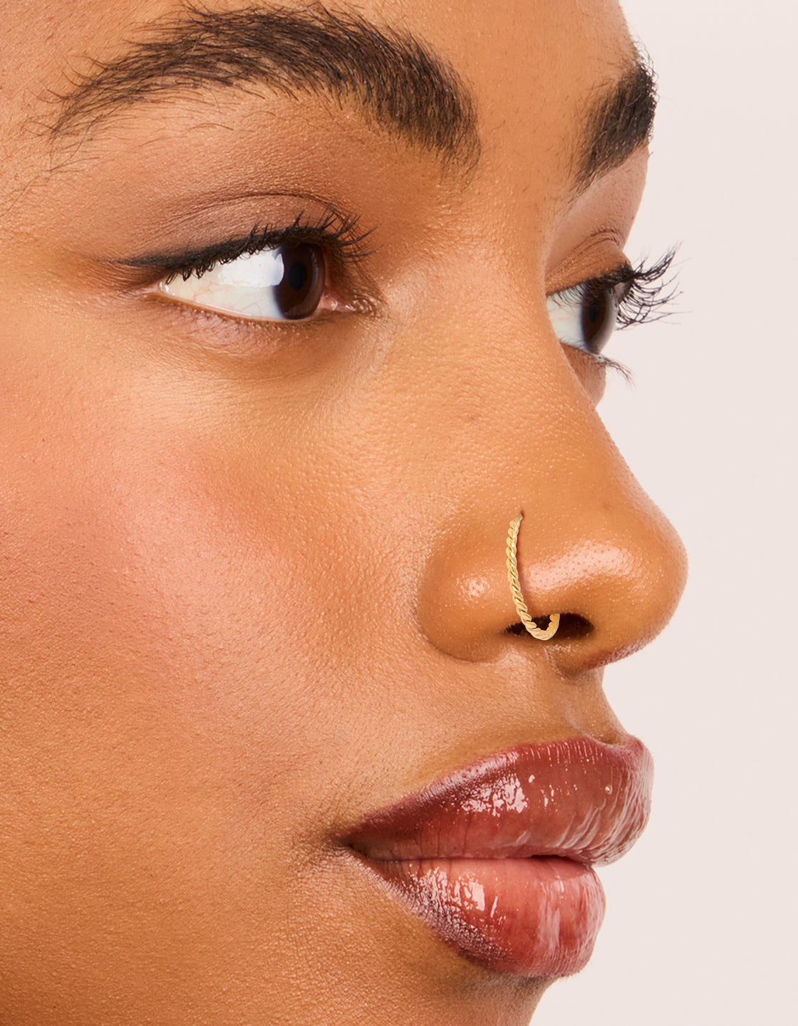 Featuring mixed metal plated surgical steel diamante twist nose rings and studs 4-pack with balls and diamond in gold plated stud closure nose view