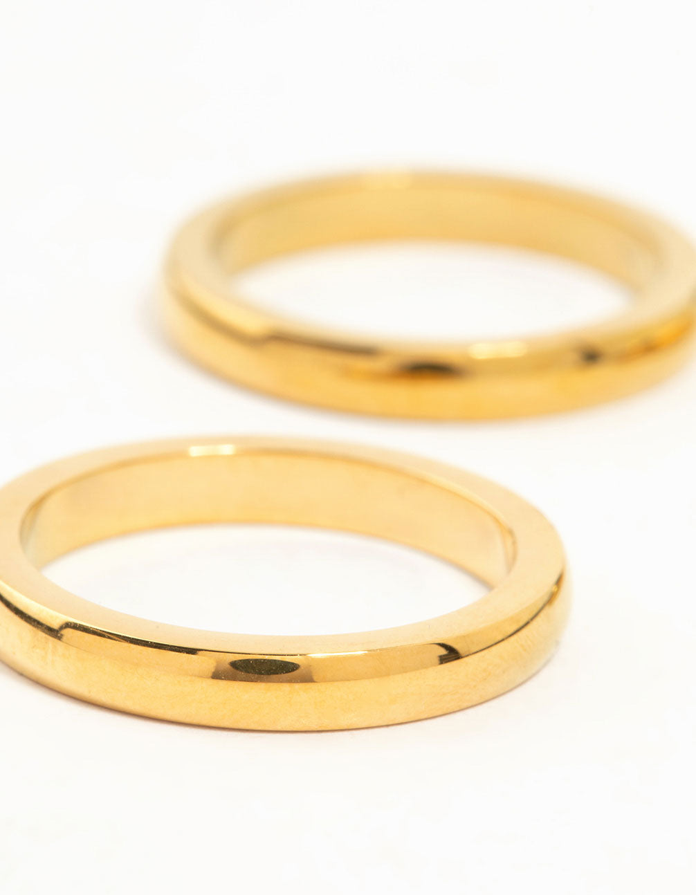 Showcasing waterproof gold plated stainless steel band rings in a 3-pack close up view