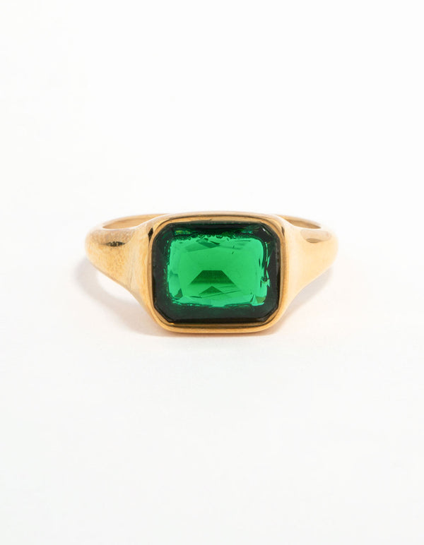 Featuring a waterproof signet ring made of gold plated stainless steel with an opulent green cubic zirconia crystal close up view