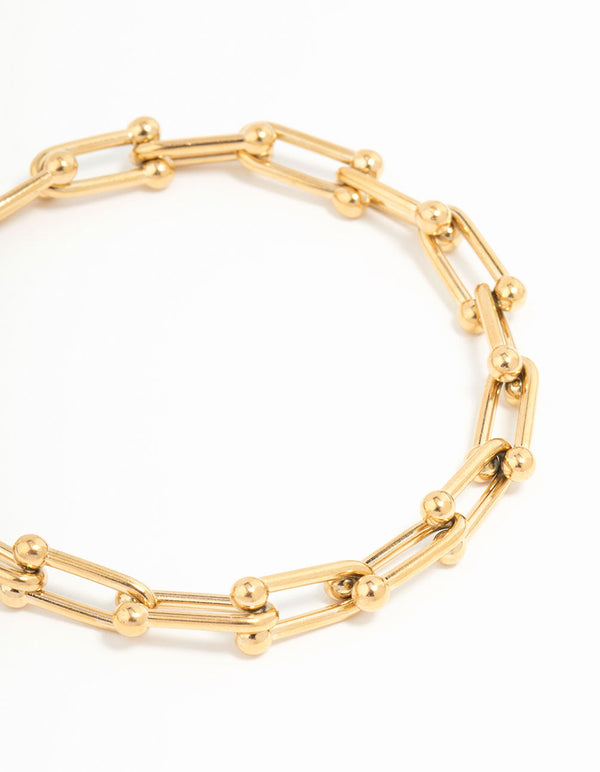 Featuring a waterproof hardware chain bracelet in gold plated stainless steel close up view