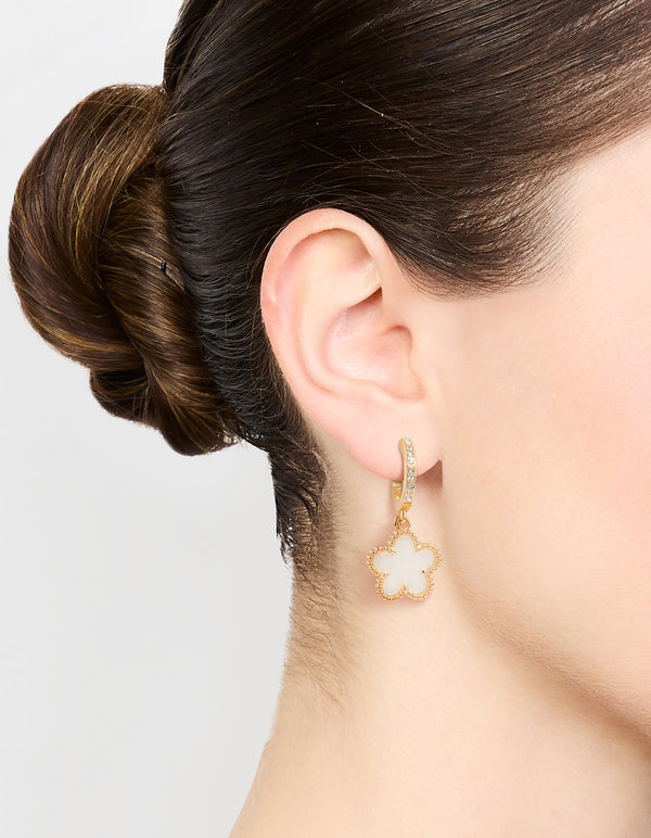 Showcasing gold plated flower drop diamante hoop earrings in white on ear view