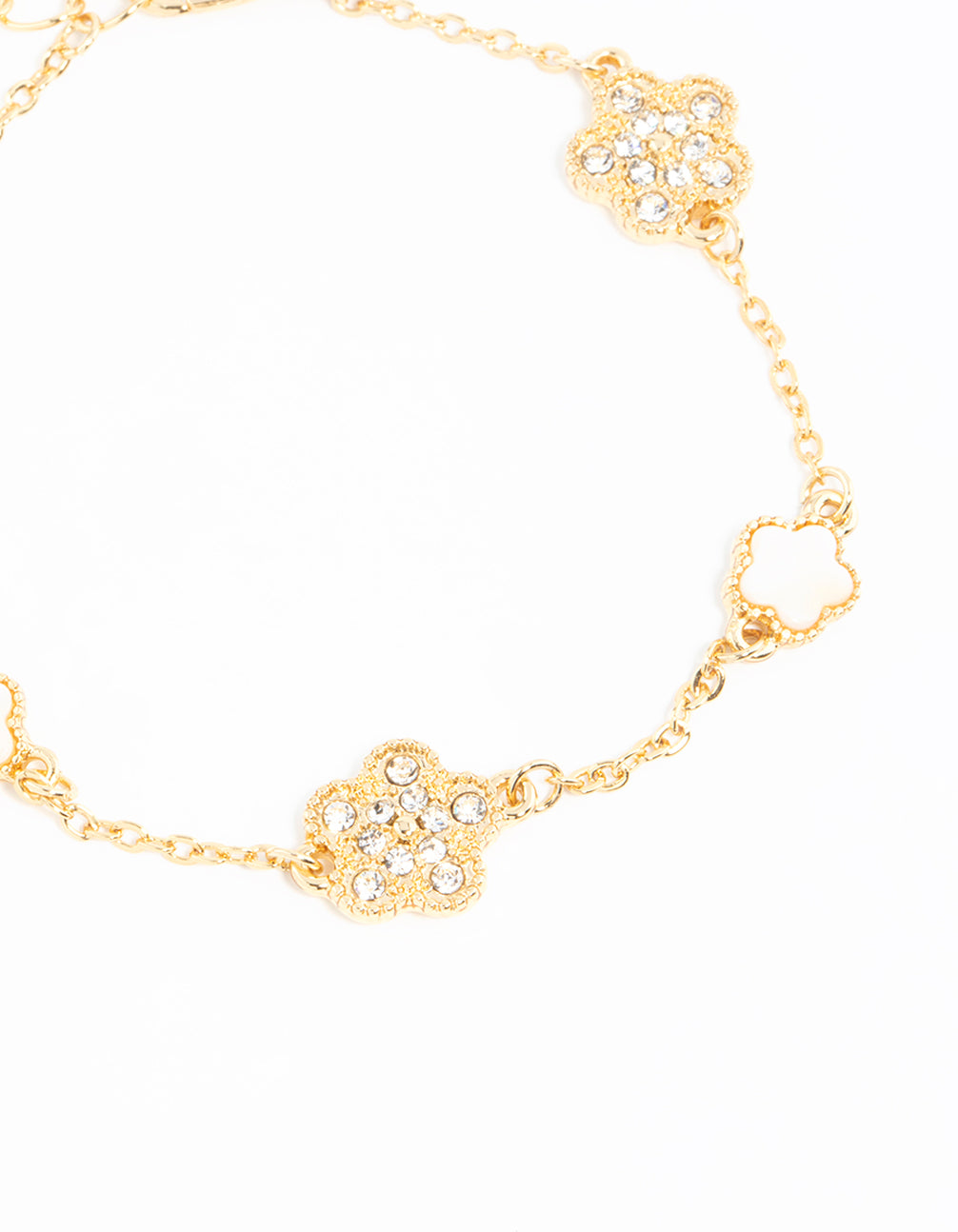 Detailed view of a gold plated alternating small and medium flower bracelet with charm accents in white close up view
