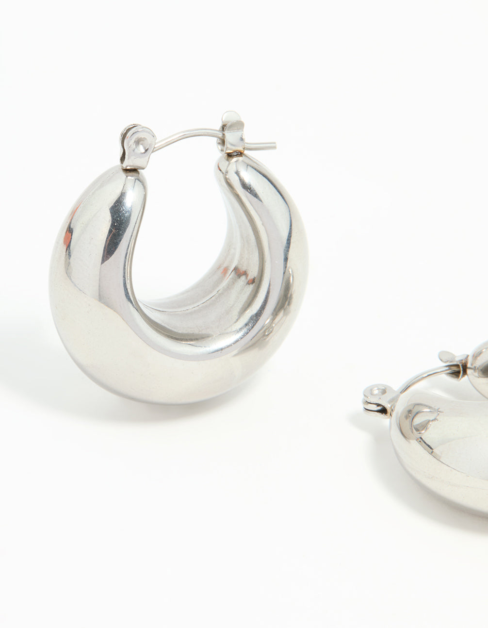 Displaying waterproof stainless steel full bubble hoop earrings in silver close up view