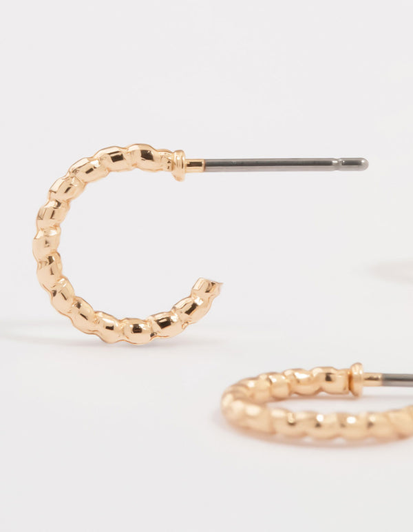 Designed with gold cubic zirconia heart and twisted huggie earrings in a 3-pack featuring bar and charm details post detail view