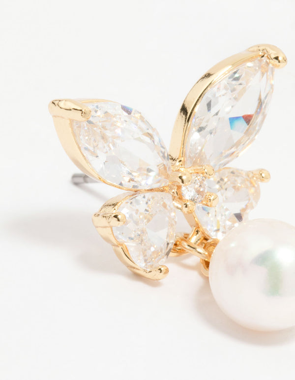 Detailed view of gold plated cubic zirconia butterfly pearl drop earrings with prong settings close up view