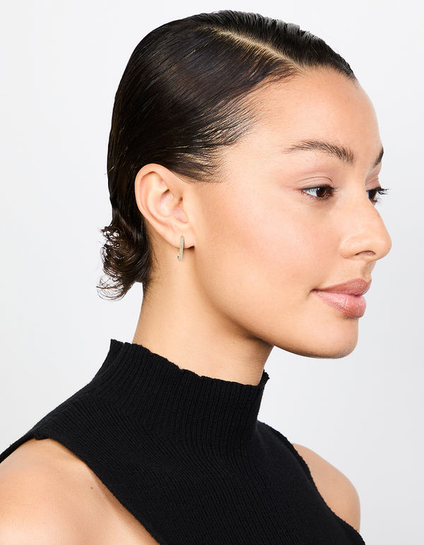Showcasing gold plated diamante oval hoop earrings with clear stones styled on model view