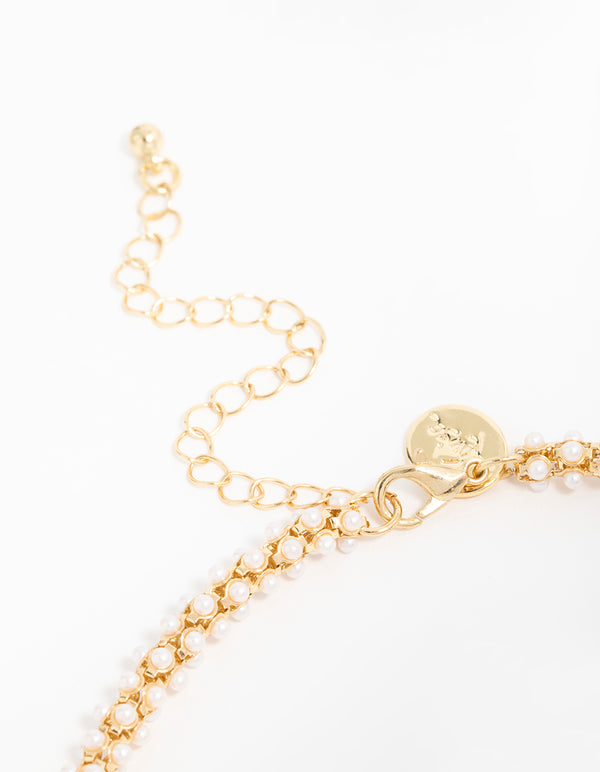 Displaying gold plated pearl fireball bracelet closure detail view