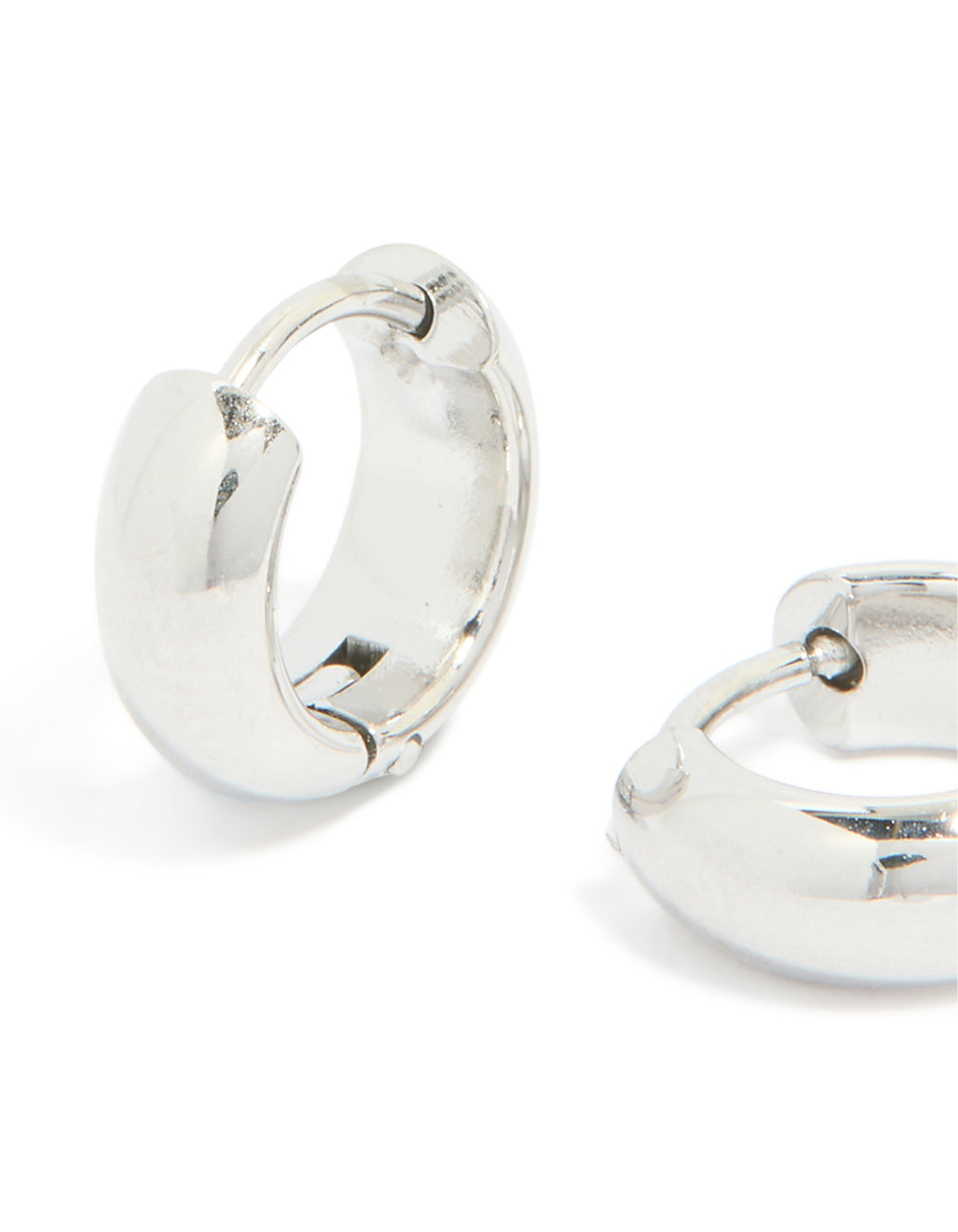 Showcasing chunky waterproof stainless steel huggie earrings in silver close up view