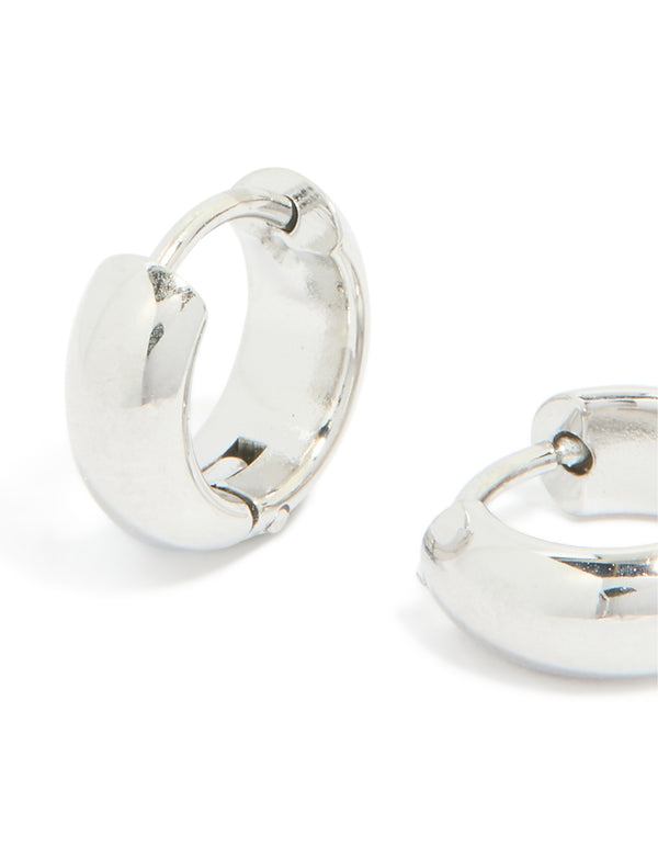 Showcasing chunky waterproof stainless steel huggie earrings in silver close up view