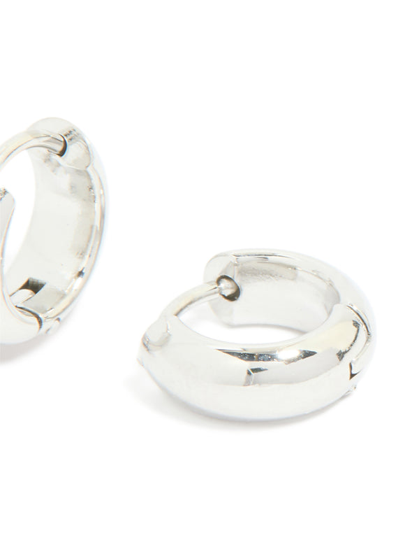 Highlighting chunky waterproof stainless steel huggie earrings in silver post detail view