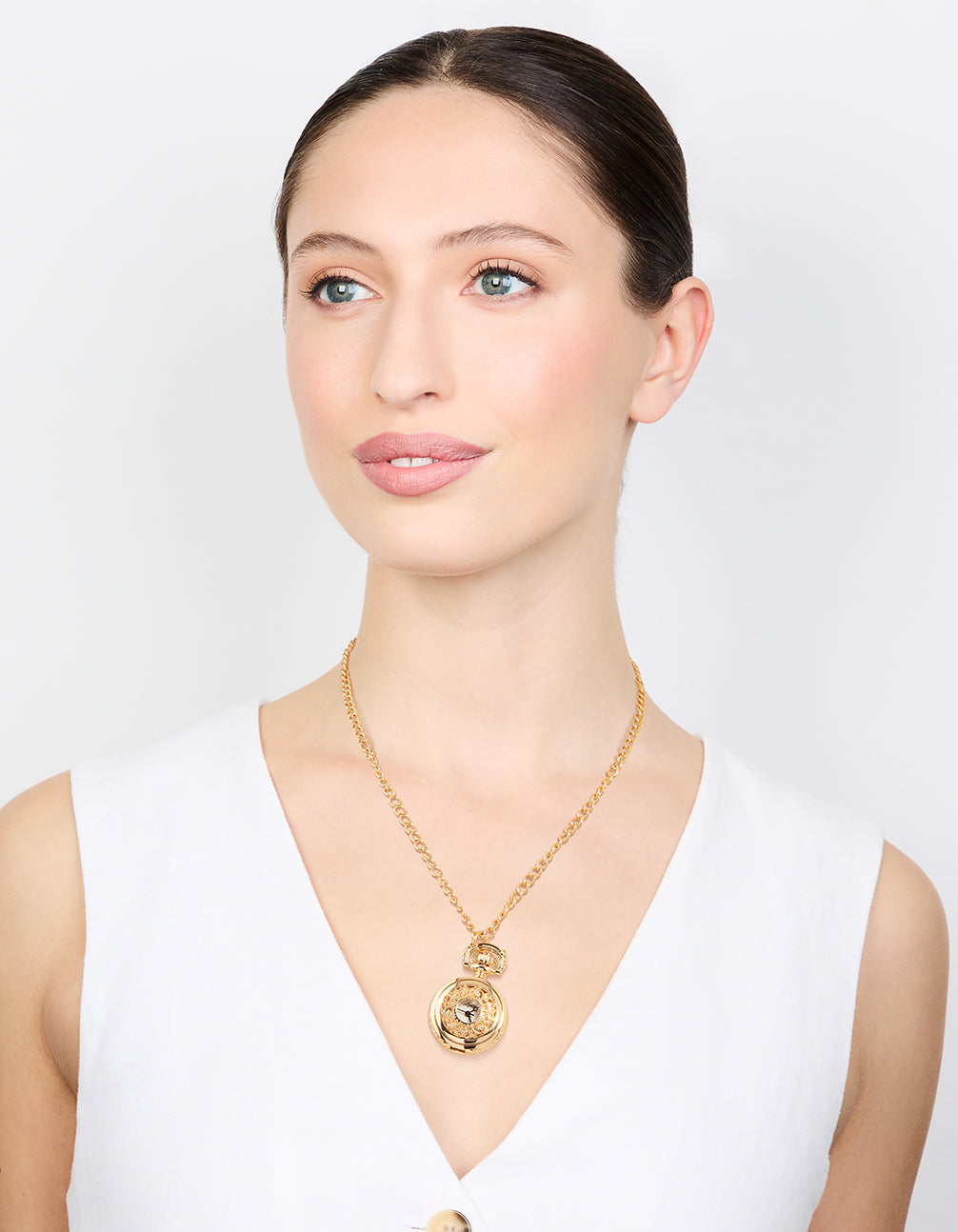 Stunning designed gold vintage pocket watch necklace for women featuring white dial, round shape, numbers, analog display, casual look, statement style and pendant feature on model view