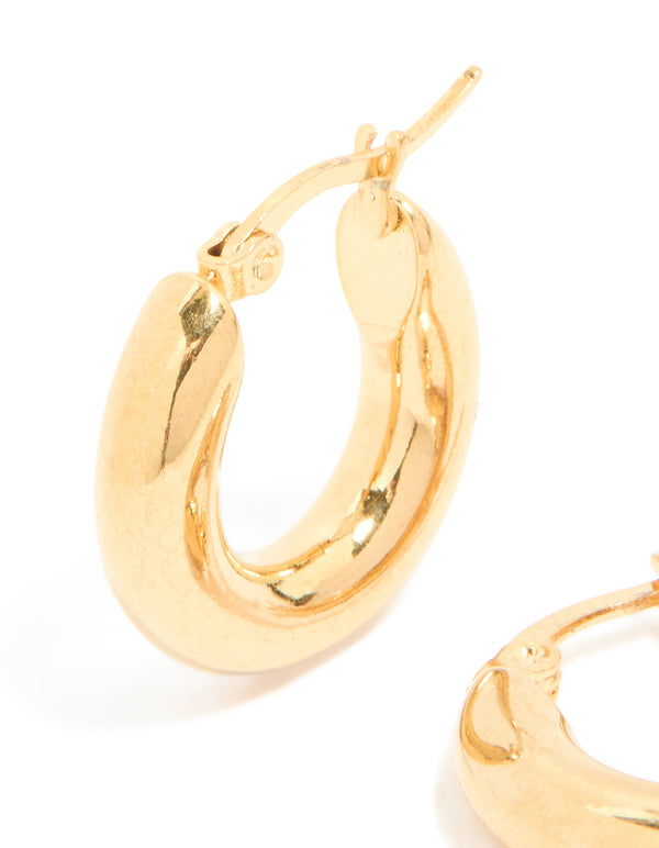 Highlighting chunky waterproof gold plated stainless steel hoop earrings with polished texture close up view