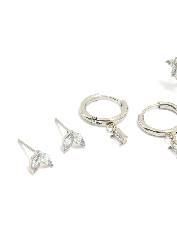 Featuring waterproof stainless steel cubic zirconia and baguette flower huggie earrings in a 4-pack with floral design in silver and clear stones close up view