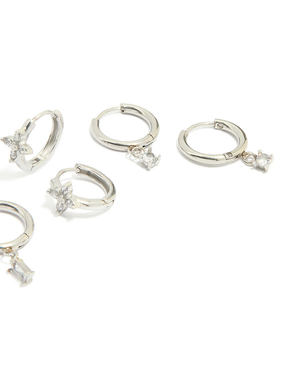 Crafted from waterproof stainless steel, cubic zirconia and baguette flower huggie earrings in a 4-pack with floral design in silver and with clear stones post detail view