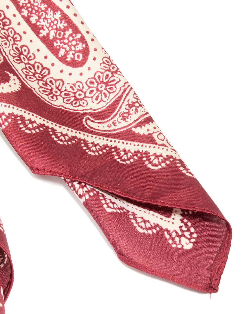 Showcasing red fabric scarf with paisley print in red and antique white detail view