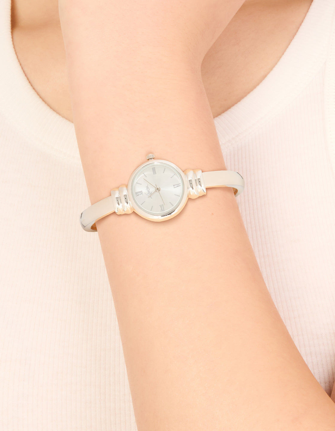 Designed with a white dial featuring roman numerals, this women's formal analog watch in bangle style on wrist view