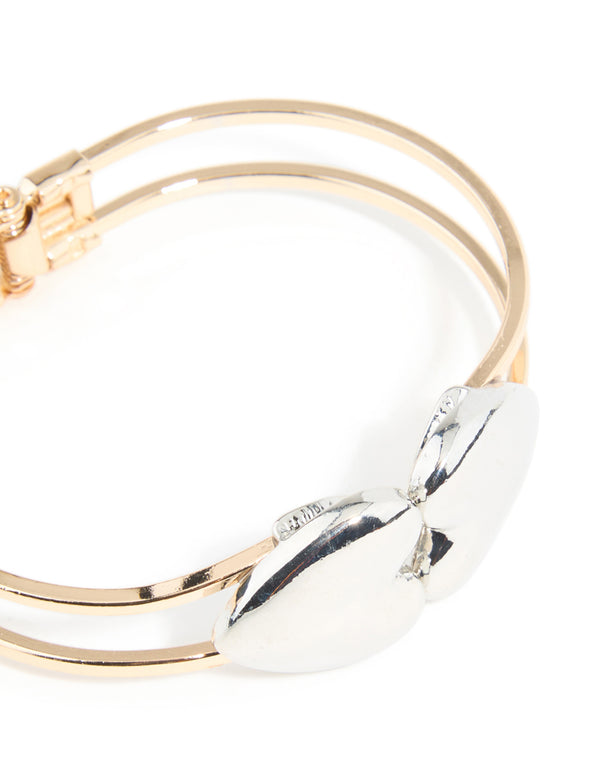 Crafted from mixed metals with heart hinged bangle close up view