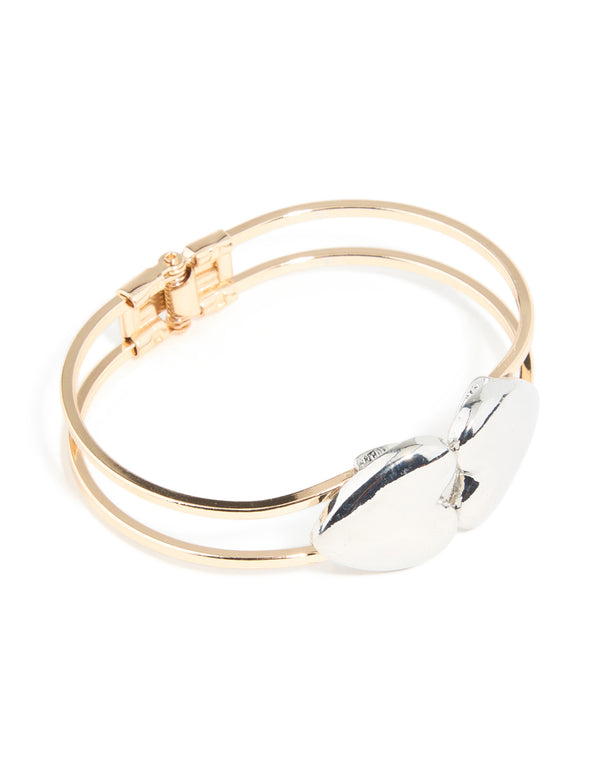 Showcasing a heart hinged bangle crafted from mixed metals in front view