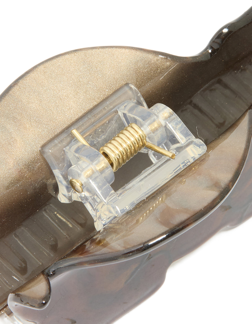 Close-up of the dog-shaped acrylic claw clip revealing gold spring mechanism and tan accents detail view