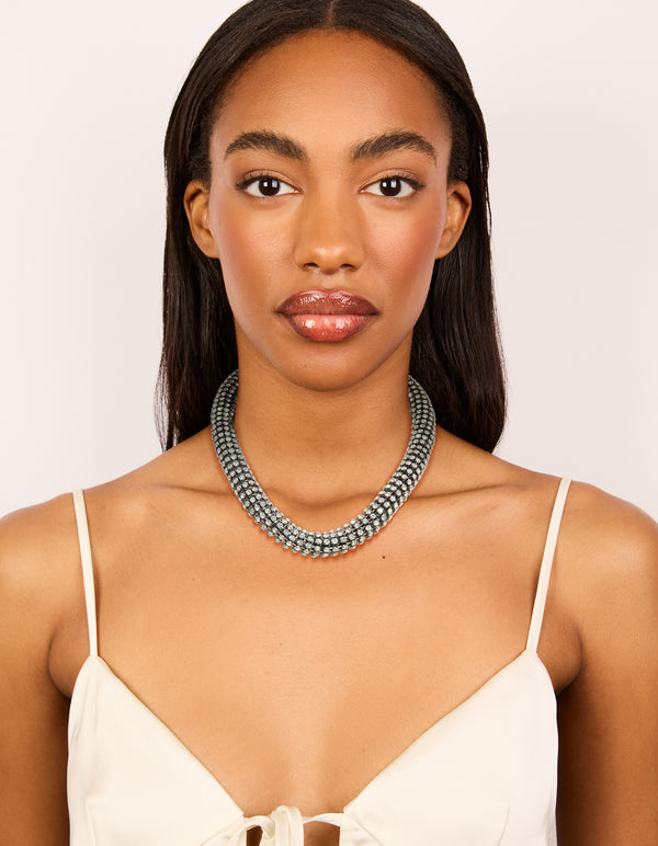 Presenting a gunmetal diamante tube necklace in silver with statement styling on model view