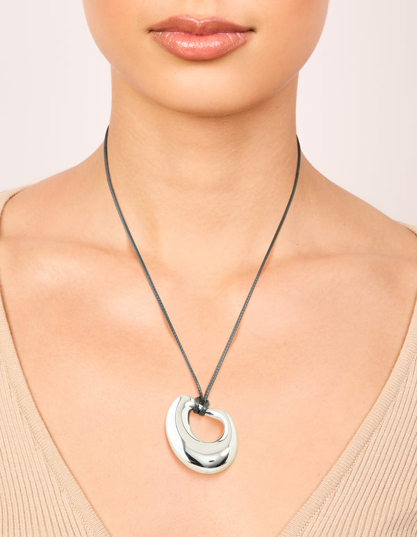 Featuring a waterproof stainless steel open molten pendant cord necklace in silver and dimgrey on neck view