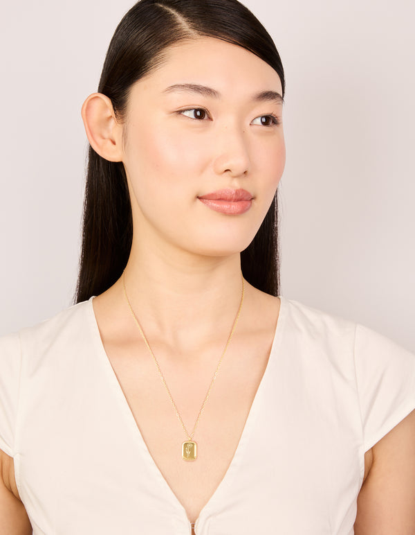 Featuring a waterproof gold plated stainless steel floral pendant necklace on model view