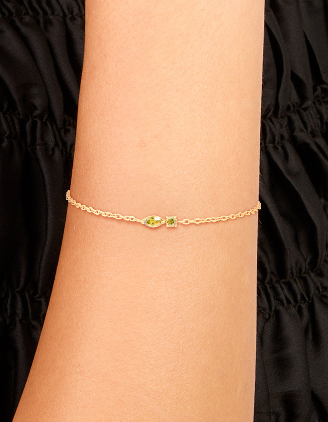 Discover a waterproof gold plated stainless steel August light green cubic zirconia birthstone bracelet on wrist view