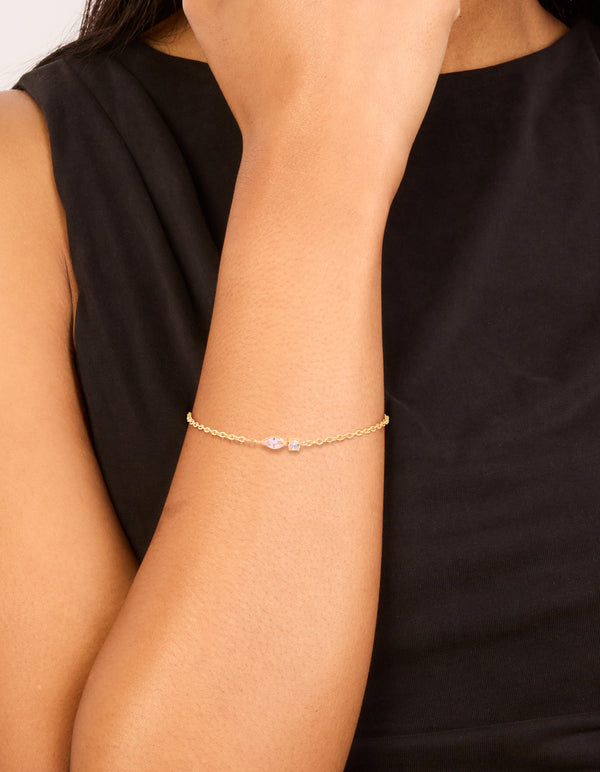 Featuring a waterproof bracelet in gold plated stainless steel with pink cubic zirconia detailing on wrist view