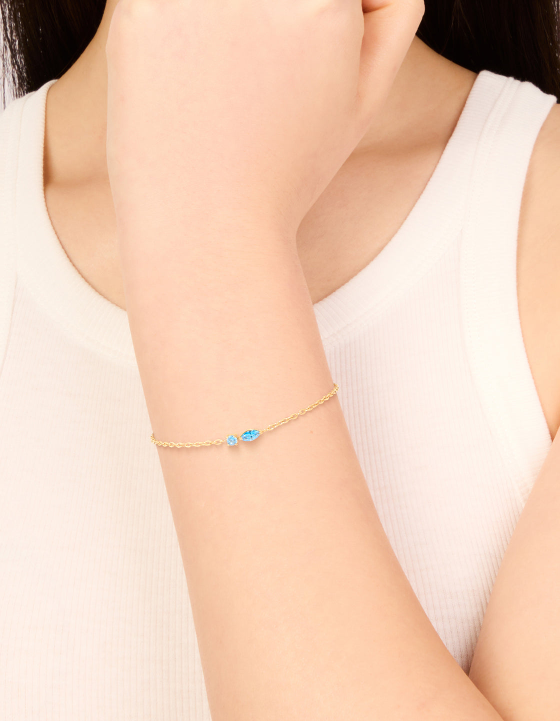Featuring a waterproof gold plated stainless steel December blue cubic zirconia birthstone bracelet on wrist view