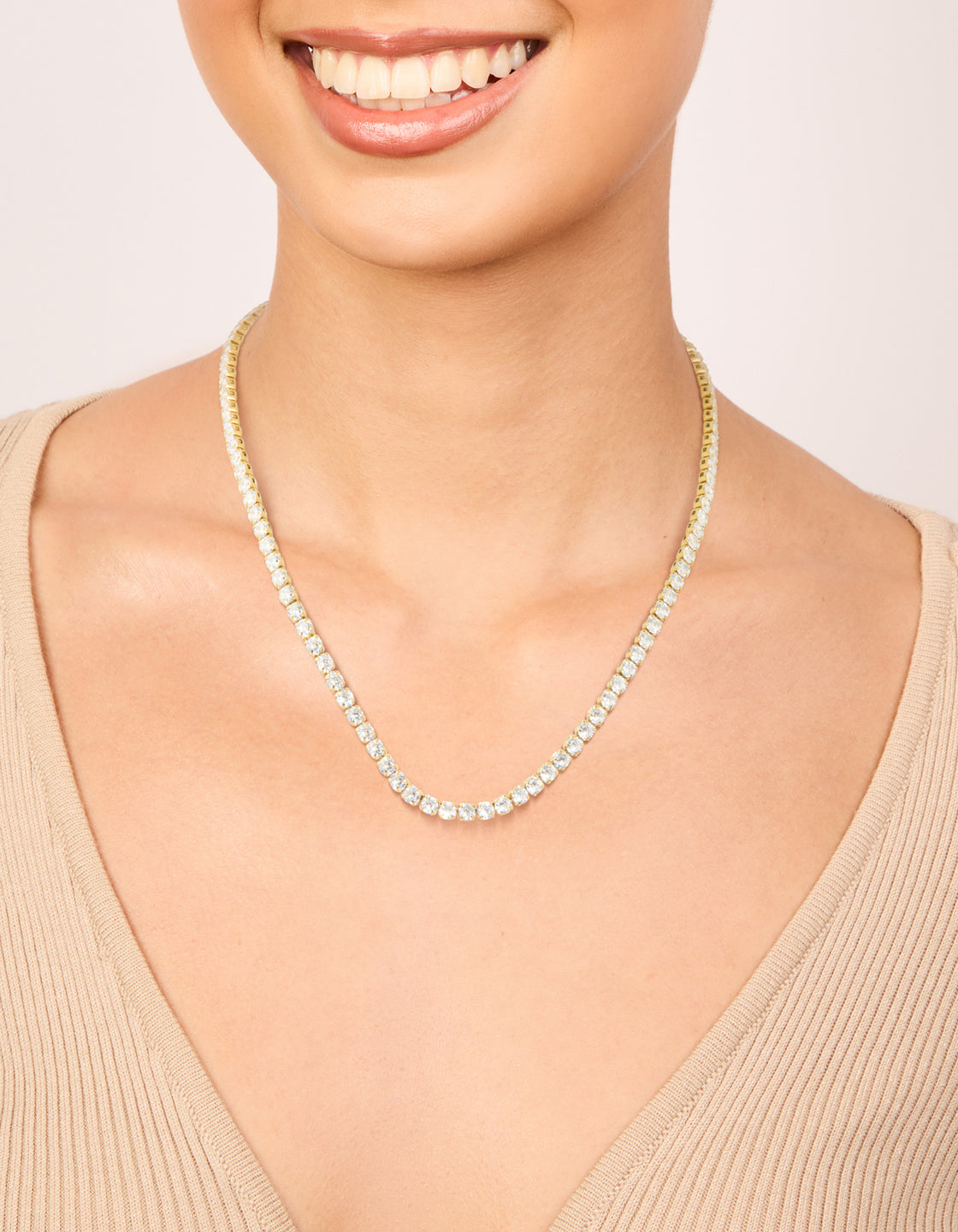Showcasing a waterproof tennis necklace featuring gold plated stainless steel with cubic zirconia stones on neck view