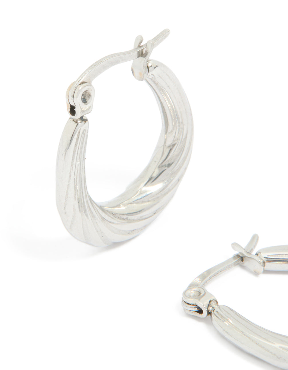 Designed with waterproof textured stainless steel oval hoop earrings in silver close up view