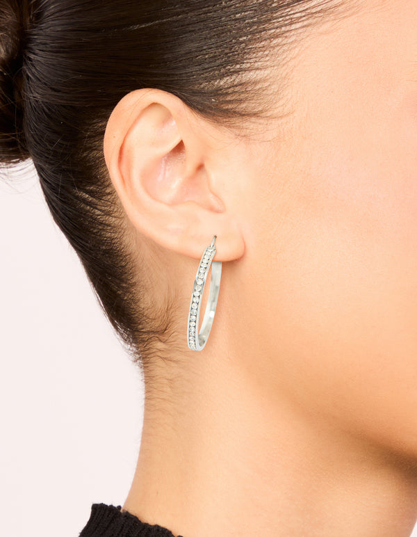 Featuring waterproof stainless steel diamante hoop earrings in silver 35 MM on ear view