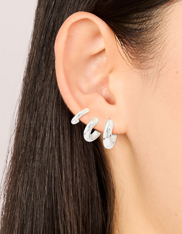 Crafted from waterproof stainless steel, multi-sized hoop earrings in a 3-pack with silver color on ear view
